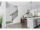 Modern kitchen open to living area with countertop seating and stairs at 1190 Buice Lake Pkwy, Acworth, GA 30102