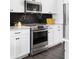 Modern kitchen features stainless steel appliances, sleek white cabinetry, and stylish backsplash at 1190 Buice Lake Pkwy, Acworth, GA 30102