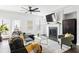 Open living room featuring a fireplace, ceiling fan and plenty of light at 1190 Buice Lake Pkwy, Acworth, GA 30102