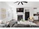 Bright living room boasts a fireplace, ceiling fan and hardwood floors at 1190 Buice Lake Pkwy, Acworth, GA 30102