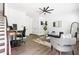 Well-lit living area featuring hardwood floors, modern furniture, and a home office setup at 1190 Buice Lake Pkwy, Acworth, GA 30102