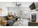 Well-lit living room with fireplace, ceiling fan, and sliding glass door to deck at 1190 Buice Lake Pkwy, Acworth, GA 30102