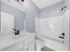 Clean bathroom features a combined shower-tub, white vanity and bronze-finished fixtures at 5345 Mirror Lake Dr, Cumming, GA 30028