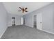 A well-lit bedroom with multiple access doors to a closet and bathroom at 5345 Mirror Lake Dr, Cumming, GA 30028