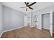 A neutral bedroom features a ceiling fan and doors to a bathroom and closet at 5345 Mirror Lake Dr, Cumming, GA 30028