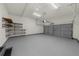 Spacious two-car garage featuring overhead storage and durable flooring, providing ample room for vehicles at 5345 Mirror Lake Dr, Cumming, GA 30028