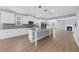 Open-concept kitchen with granite countertops, stainless appliances, and a fireplace at 5345 Mirror Lake Dr, Cumming, GA 30028