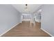 Spacious open-concept living room featuring pristine floors, light walls, and stylish lighting at 5345 Mirror Lake Dr, Cumming, GA 30028
