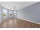 Bright living room with bay windows, and elegant lighting at 5345 Mirror Lake Dr, Cumming, GA 30028