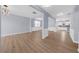 Spacious open-concept living room with pristine floors, light walls, and modern lighting at 5345 Mirror Lake Dr, Cumming, GA 30028