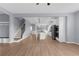 Open-concept living room flowing into a modern kitchen and staircase, enhancing the home's appeal at 5345 Mirror Lake Dr, Cumming, GA 30028