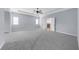 Spacious main bedroom features a tray ceiling, ceiling fan, two windows, and an ensuite bathroom at 5345 Mirror Lake Dr, Cumming, GA 30028