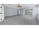 Spacious main bedroom with a tray ceiling, ceiling fan, and a large attached seating area at 5345 Mirror Lake Dr, Cumming, GA 30028