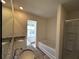 Granite countertops and a soaking tub with a shower make this bathroom complete at 1911 Victoria Way # 117, Conyers, GA 30013