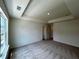Large bedroom with tray ceilings with multiple closets and carpet flooring at 1911 Victoria Way # 117, Conyers, GA 30013
