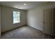 Neutral bedroom with carpet and a large window at 1911 Victoria Way # 117, Conyers, GA 30013