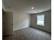 Bright bedroom features neutral walls, carpet, and a window providing natural light at 1911 Victoria Way # 117, Conyers, GA 30013