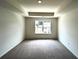 Spacious bedroom featuring tray ceilings and a large window, providing ample natural light at 1911 Victoria Way # 117, Conyers, GA 30013