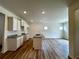An open-concept kitchen featuring white cabinets, granite countertops, and a central island, ideal for entertaining at 1911 Victoria Way # 117, Conyers, GA 30013