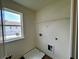 Convenient laundry room featuring a window and washer/dryer hookups at 1911 Victoria Way # 117, Conyers, GA 30013