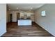 Bright, open-concept living area featuring modern flooring, a kitchen island, and ample natural light at 1911 Victoria Way # 117, Conyers, GA 30013
