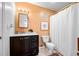 Bathroom with dark cabinets, white fixtures, and tile flooring at 3049 Heathgate Ct, Lawrenceville, GA 30044