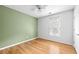 Bedroom with hardwood floors, green accent wall, and a bright window at 3049 Heathgate Ct, Lawrenceville, GA 30044
