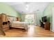 Spacious bedroom features light hardwood floors, a ceiling fan, and large window at 3049 Heathgate Ct, Lawrenceville, GA 30044