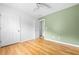 Bright bedroom featuring hardwood floors, a ceiling fan, and a closet door at 3049 Heathgate Ct, Lawrenceville, GA 30044