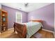 Bedroom with wood floors, a wooden bed frame, and a built-in bookshelf at 3049 Heathgate Ct, Lawrenceville, GA 30044