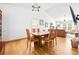 Sunlit dining room with wood floors, neutral walls, high ceilings, and adjoins to living room at 3049 Heathgate Ct, Lawrenceville, GA 30044