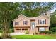 Charming two-story home with a well-manicured lawn, attached garage, and inviting entrance at 3049 Heathgate Ct, Lawrenceville, GA 30044