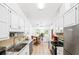 Clean kitchen with white cabinets, stainless appliances, neutral countertop, and breakfast area at 3049 Heathgate Ct, Lawrenceville, GA 30044