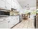Modern kitchen features white cabinets, stainless steel appliances, and a bright breakfast nook at 3049 Heathgate Ct, Lawrenceville, GA 30044