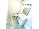Bathroom with gray marble pattern flooring, toilet, sink, vanity, framed mirror and bronze colored light fixture above mirror at 4701 Flat Shoals Rd # 68D, Union City, GA 30291