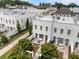 Beautiful aerial view of white brick townhouses with manicured lawns and outdoor patio areas perfect for entertaining at 323 S Esplanade, Alpharetta, GA 30009