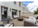 Inviting back patio featuring a fire pit, seating, and outdoor dining, ideal for relaxation and entertaining at 323 S Esplanade, Alpharetta, GA 30009