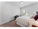 Bright bedroom with white walls, a plush bed, and a small desk by the window at 323 S Esplanade, Alpharetta, GA 30009