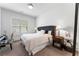 Cozy bedroom with a tufted headboard, side tables with lamps, and comfortable seating at 323 S Esplanade, Alpharetta, GA 30009