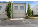 Charming white townhouse with an attached garage and well-manicured landscaping at 323 S Esplanade, Alpharetta, GA 30009