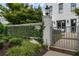 Charming front entrance with a private, ivy-covered wall and an iron gate, adding curb appeal to this property at 323 S Esplanade, Alpharetta, GA 30009