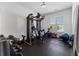 Home gym equipped with a weight machine, free weights, and a rubber floor at 323 S Esplanade, Alpharetta, GA 30009