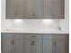 Close-up of elegant gray kitchen cabinets with subway tile backsplash and modern hardware at 323 S Esplanade, Alpharetta, GA 30009