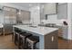 Well-appointed kitchen with stainless steel appliances, a center island, and sleek gray cabinetry at 323 S Esplanade, Alpharetta, GA 30009