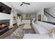 Inviting living room featuring a fireplace, white sofa, and seamless flow into the dining and kitchen areas at 323 S Esplanade, Alpharetta, GA 30009