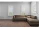 Comfortable living room area with a sectional sofa and natural light through shuttered windows at 323 S Esplanade, Alpharetta, GA 30009