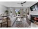 Elegant living room featuring a fireplace, hardwood floors, and French doors leading to the patio at 323 S Esplanade, Alpharetta, GA 30009