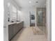 Elegant main bathroom with double vanity, tiled floors, and a glass enclosed shower at 323 S Esplanade, Alpharetta, GA 30009