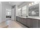 Tastefully decorated main bathroom featuring a double vanity with a large mirror at 323 S Esplanade, Alpharetta, GA 30009
