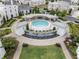 A community pool with a unique fountain and seating areas surrounded by lush landscaping at 323 S Esplanade, Alpharetta, GA 30009